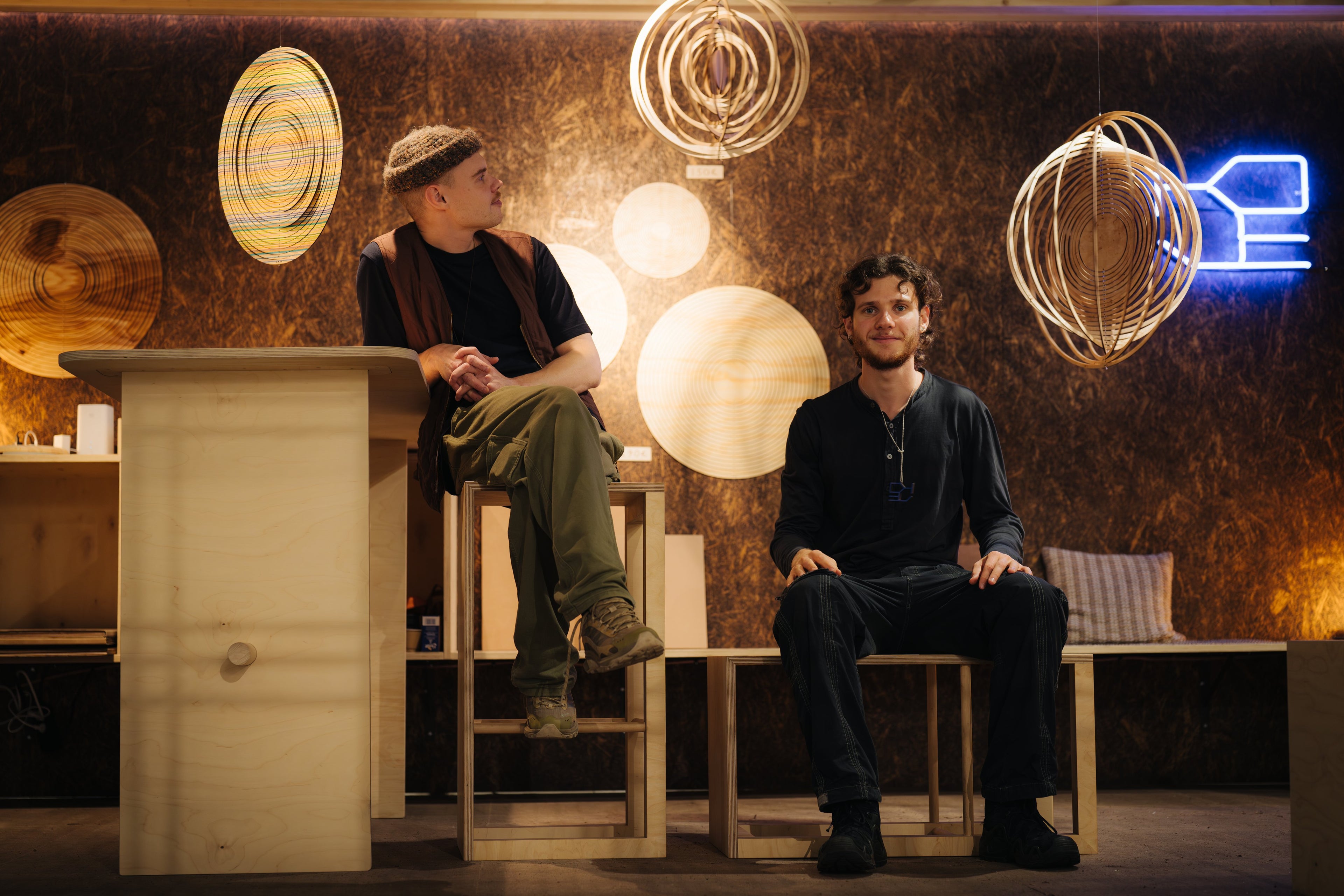 Two founders of Koje sit in Koje booth during Habitare 2025 inspired by tradition and modern technology sci-fi