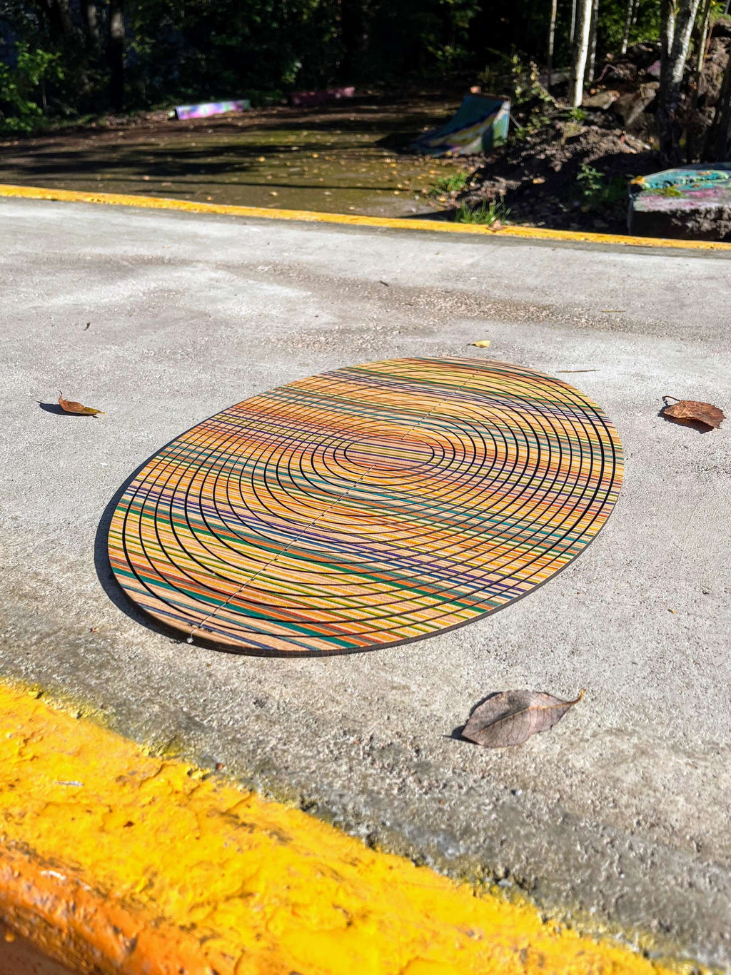 oval colourful cycloop made out of recycled skateboards